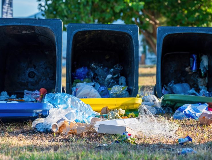 Dropped dumpsters with fallen out trash on the ground, Olympiada, Greece